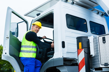 crane operator driving with truck of construction site