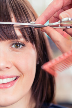 Hairdresser Cutting Woman Bangs Hair In Shop