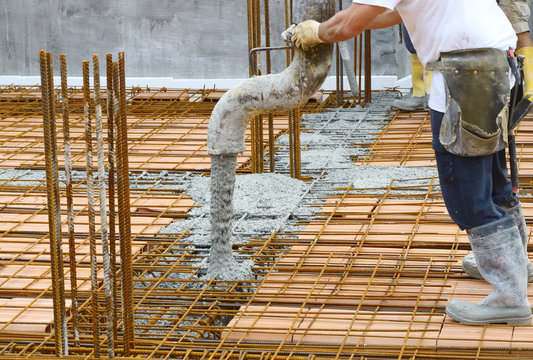 Workers pouring concrete with motion blur