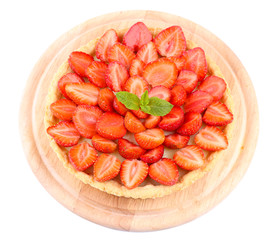 Strawberry tart with green mint leaves isolated on white