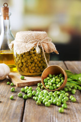Fresh  and canned peas in bowl and glass jar
