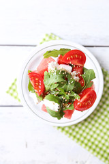 Salad with watermelon, feta cheese, arugula, tomatoes, sesame