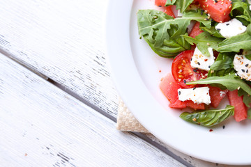 Salad with watermelon, feta, arugula and basil leaves