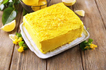 Tasty lemon cake on wooden table