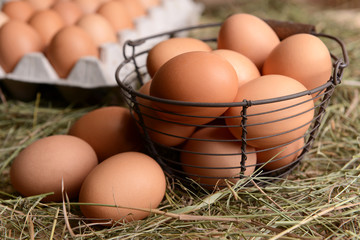 Eggs in wicker basket on table close-up