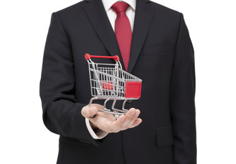 Shopping cart in businessman hand with clipping path
