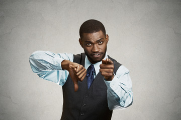 Displeased customer executive man giving thumbs down gesture