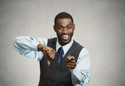 Company man excited about someones failure, grey wall background