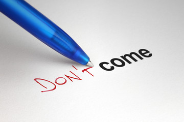 Don't come. Written on white paper