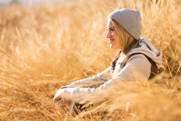woman sitting on autumn grass