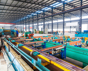 Industrial zone, steel pipelines and cables in a plant