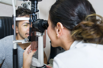 Optical exam to young man, professional woman