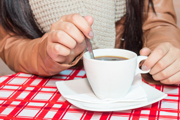 Girl's hands holding cup of coffee