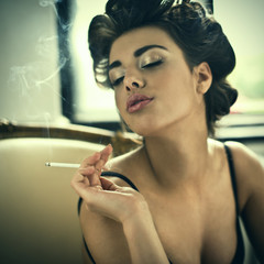 Obraz premium Retro style smoking fashion woman portrait on arm chair