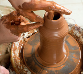 hands of a potter, creating an earthen jar