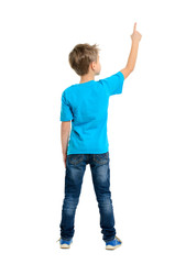 Rear view of a school boy over white background pointing upwards - 68056935