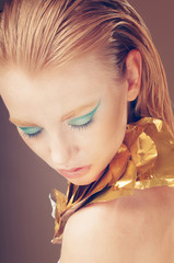 Fashion portrait of glamour Model girl with blue and golden Make