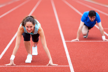 Woman racing with a man at the stadium