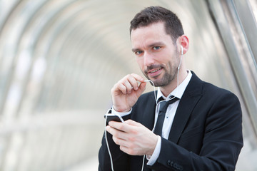 Portrait of an attractive businessman using handsfree set