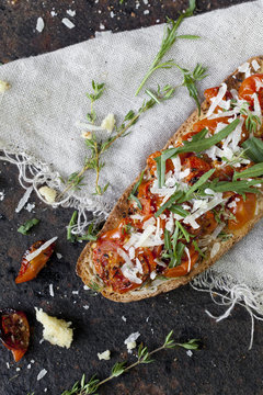 bruschetta with baked cherry tomatoes, parmesan and rocket