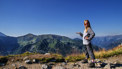 Blond girl in mountains