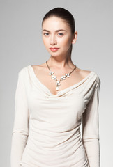 beautiful woman wearing marble necklace on grey background - 68061377