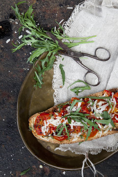 bruschetta with baked cherry tomatoes parmesan and rocket