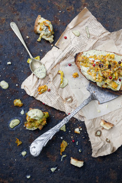 toasted bread with basil sauce and zucchini blossoms