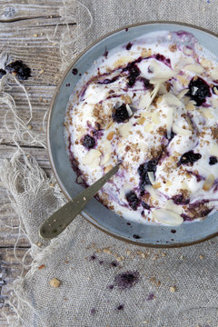 white yogurt with blackberries muesli and almond slices