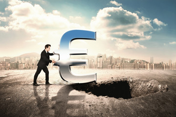 Businessmen pushing icon of euro into a hole in the ground