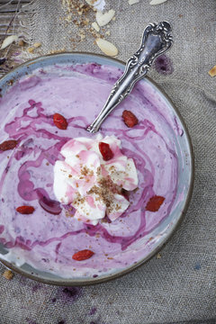dessert with blackberries yogurt whipped cream and goji berries