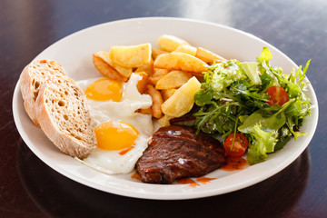 steak with eggs and vegetables