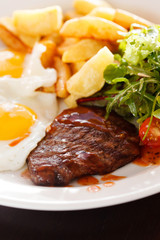 steak with eggs and vegetables