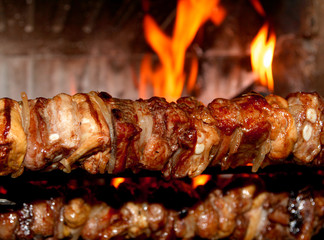 spit roast with meat cooked on a spit in the fireplace 1