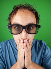 Thirty year old man with 3d glasses in shock watching a movie