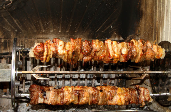 meat skewers cooked to spit in the fireplace swivel