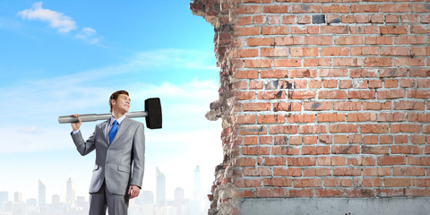 Businessman holding hammer