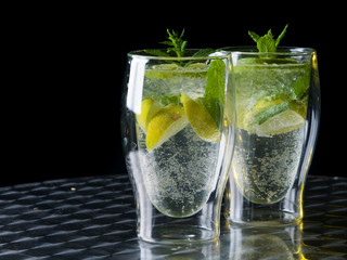Green cocktail mojito on dark background.