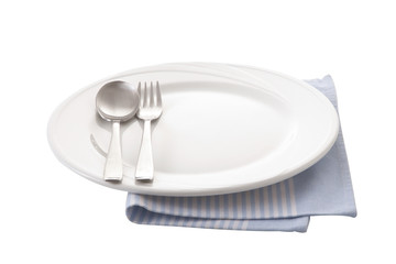 spoon and fork in white ceramic dish on napkin