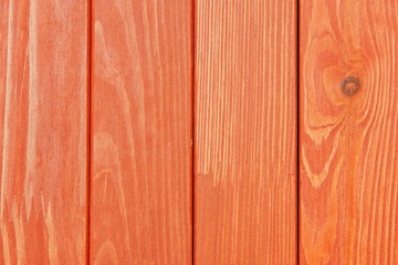 the textured wooden surface of bright red color