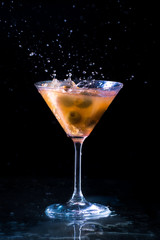 alcoholic drink with ice cubes, isolated on black background
