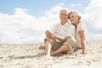 Attractive elderly people enjoy the sea breeze