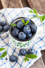 Fresh blueberry in the mug