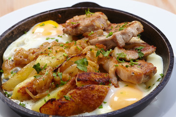 fried meat with potatoes and egg