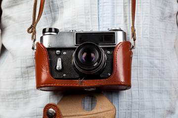 Old film photo camera in leather case