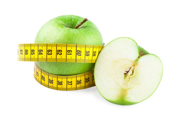 Healthy food and diet concept. Green apples and measuring tape