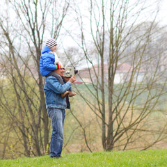  Grandfather Carrying Grandson On His Shoulders. 