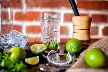 fresh made mint mojito cocktail drink with ingredients at bar