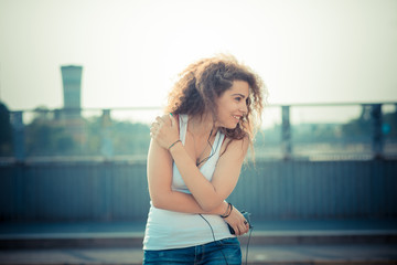 Obraz premium young beautiful long curly hair hipster woman listening music