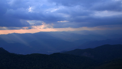 dark landscape with mountains at sunset